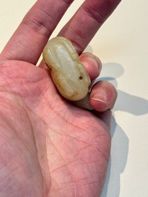 A Chinese white and russet jade pendant in the form of a horse, Song/Ming — photo 3