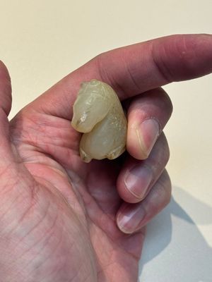 A Chinese white and russet jade pendant in the form of a horse, Song/Ming — photo 5