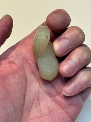 A Chinese white and russet jade pendant in the form of a horse, Song/Ming — photo 6