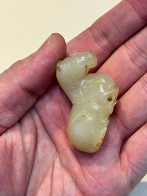 A Chinese white and russet jade pendant in the form of a horse, Song/Ming — photo 7