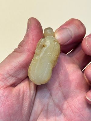 A Chinese white and russet jade pendant in the form of a horse, Song/Ming — photo 8