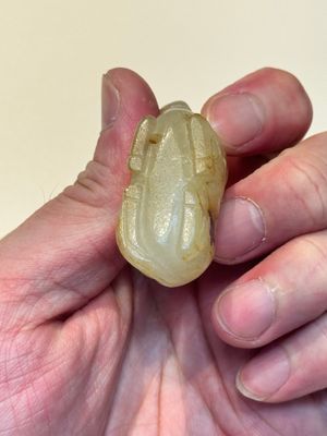 A Chinese white and russet jade pendant in the form of a horse, Song/Ming — photo 9