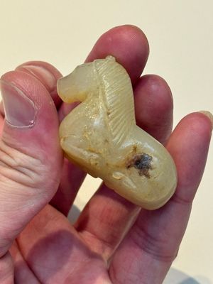 A Chinese white and russet jade pendant in the form of a horse, Song/Ming — photo 10