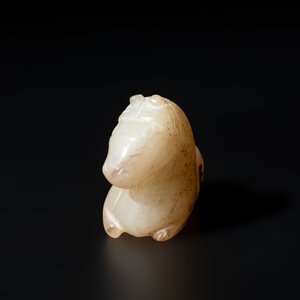A Chinese white and russet jade pendant in the form of a horse, Song/Ming — photo 3