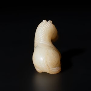A Chinese white and russet jade pendant in the form of a horse, Song/Ming — photo 5