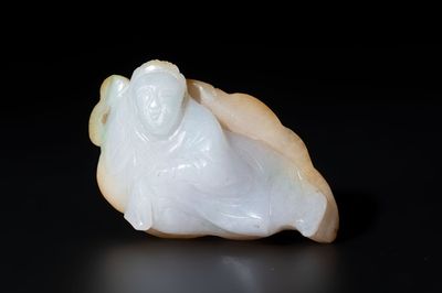A Chinese white and yellow jade carving of a reclining lady on a leaf, Qing