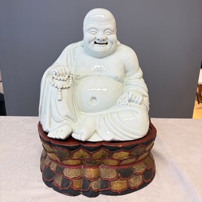 A Chinese white-glazed Milefo Buddha on a gilt-lacquered wooden lotus throne — photo 1