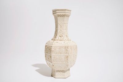 A Chinese white-glazed relief-decorated vase with text bands, 19th C.
