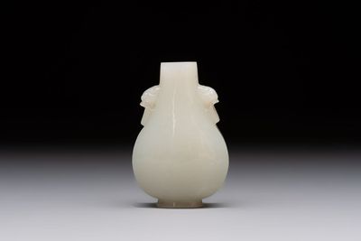 A Chinese white jade snuff bottle with lion-form handles, 19th C.