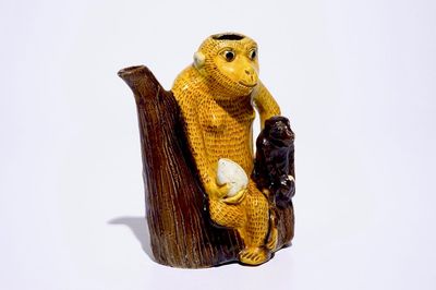 A Chinese yellow and aubergine glazed biscuit ewer in the shape of two monkeys with peaches, Kangxi