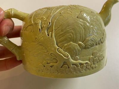 A Chinese yellow-glazed biscuit teapot, a white-glazed biscuit double gourd vase and an iron-red 'phoenix' jar, 20th C. — photo 20