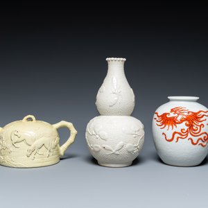 A Chinese yellow-glazed biscuit teapot, a white-glazed biscuit double gourd vase and an iron-red 'phoenix' jar, 20th C. — photo 2