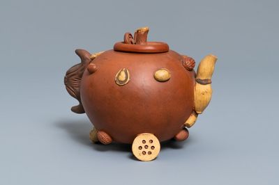 A Chinese Yixing stoneware relief-decorated teapot with nuts and fruits, impressed mark, 19th C.