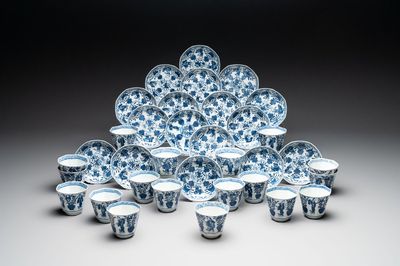 A collection of 18 Japanese blue and white cups and 17 saucers with figural and floral design, 19th C.