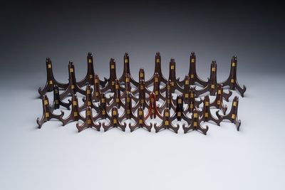 A collection of 35 Chinese folding wooden plate stands, 20th C.