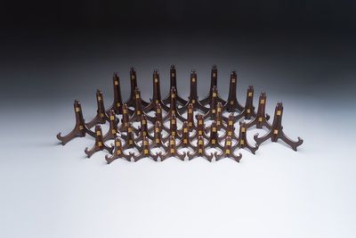 A collection of 35 Chinese wooden folding plate stands, 20th C.