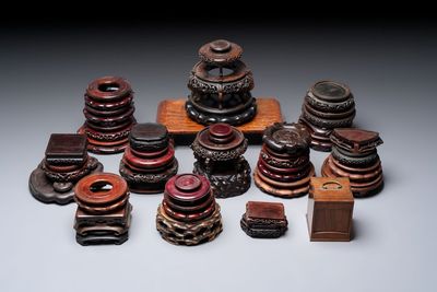 A collection of 38 Chinese wooden stands and a box, 19/20th C.