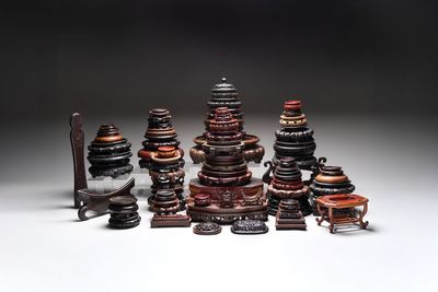 A collection of 70 Chinese wooden stands and covers, 19/20th C.