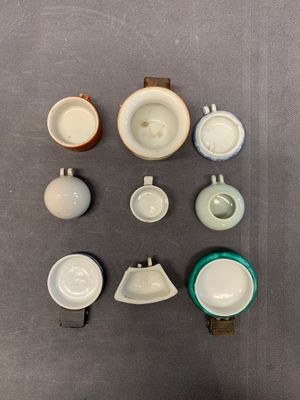 A collection of nine Chinese blue and white, monochrome and famille rose bird feeders, 19th C. — photo 1