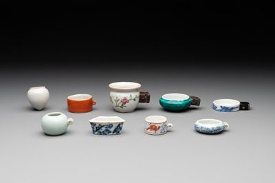 A collection of nine Chinese blue and white, monochrome and famille rose bird feeders, 19th C.