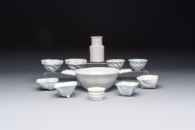 A collection of nine white-glazed Dutch Delft pudding moulds, a mustard pot and a two-handled strainer, 18th C.
