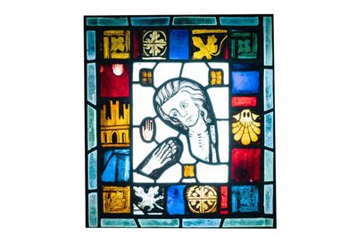 A composite stained and painted glass window mounted in lead alloy, France, 13th C. and later