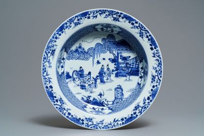 A deep Chinese blue and white dish with figures in a garden, Yongzheng