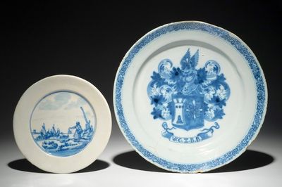 A Dutch Delft blue and white armorial dish dated 1683 and a blue and white landscape plate, 17th C.