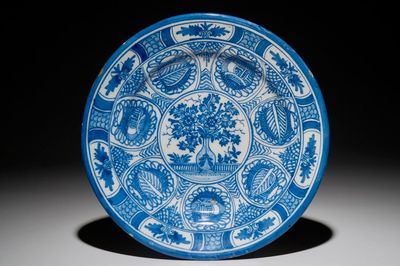 A Dutch Delft blue and white chinoiserie dish with a flower vase in Wanli style, 2nd half 17th C.