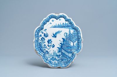 A Dutch Delft blue and white chinoiserie plaque with figures in a pagoda, 18th C.
