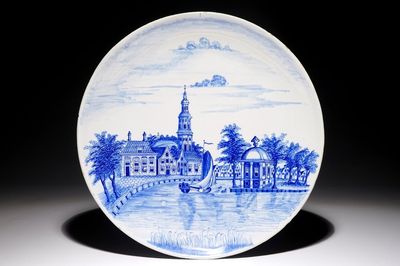 A Dutch Delft blue and white dish with a fine landscape scene, early 19th C.