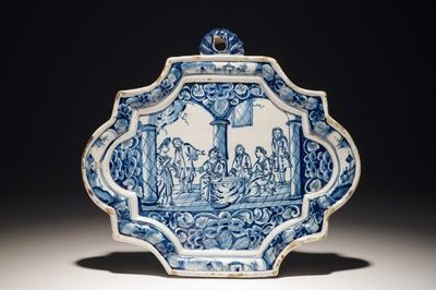 A Dutch Delft blue and white plaque with a tasting scene, 18th C.