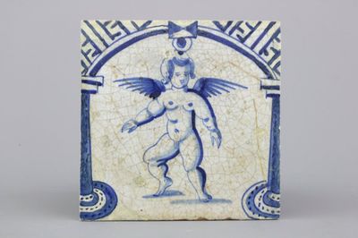 A Dutch Delft blue and white tile with a standing putto, 17th C.