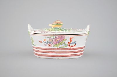 A Dutch Delft polychrome butter tub with a snail-shaped finial, 18th C.
