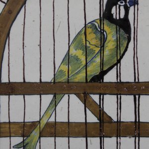 A Dutch Delft polychrome trompe l'oeil  plaque with a bird in a cage, 18th C. — 照片 1