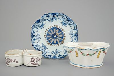 A Dutch Delft strainer, a wall flower holder and a cruet stand in French faience, 18th C.