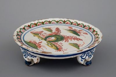 A Dutch Delft tripod saucer in cashemire palette, ca. 1700