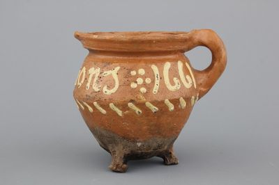 A Dutch slipware chamber pot, dated 1661