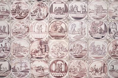 A field of 42 Dutch Delft manganese tiles with religious scenes in central medallions, 18th C.