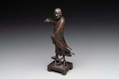 A fine Chinese bronze Luohan holding a sutra, Ming