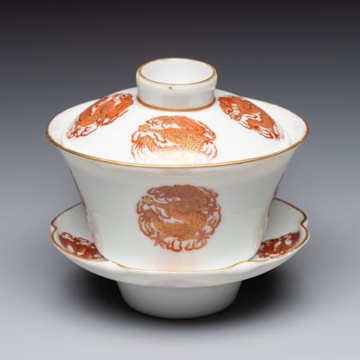 A fine Chinese iron-red and gilt-decorated 'Dragon' covered tea bowl with stand, Guangxu mark and of the period