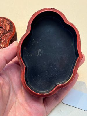 A fine Chinese red cinnabar lacquer ruyi-form 'Ba Man Xian Bao 八蠻獻寶' box and cover, Qianlong — photo 13