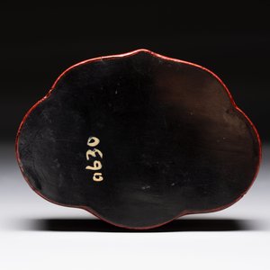 A fine Chinese red cinnabar lacquer ruyi-form 'Ba Man Xian Bao 八蠻獻寶' box and cover, Qianlong — photo 4