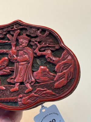 A fine Chinese red cinnabar lacquer ruyi-form 'Ba Man Xian Bao 八蠻獻寶' box and cover, Qianlong — photo 9