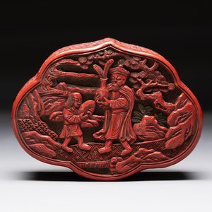 A fine Chinese red cinnabar lacquer ruyi-form 'Ba Man Xian Bao 八蠻獻寶' box and cover, Qianlong — photo 1