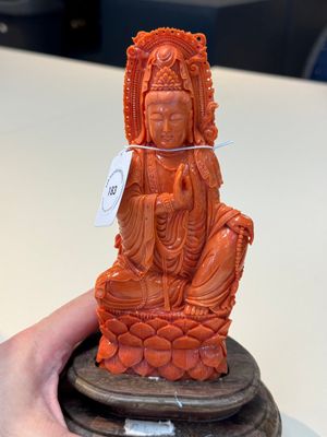A fine Chinese red coral sculpture of Guanyin seated on a lotus throne on a wooden stand, 19/20th C. — photo 5