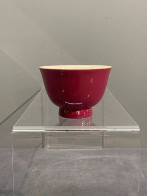 A fine Chinese ruby-ground famille rose 'magnolia' cup, Qianlong mark and of the period — photo 1
