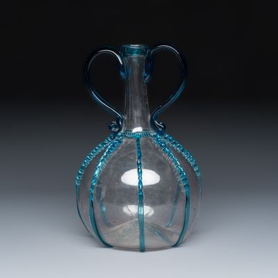 A fine Dutch two-handled blue-tinted and clear glass serving bottle, 17th C.