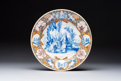 A fine polychrome Dutch Delft mixed technique 'The Faith of the Caanite Woman' plate, 18th C.