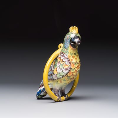 A fine polychrome Dutch Delft model of a parrot on a ring, 18th C.